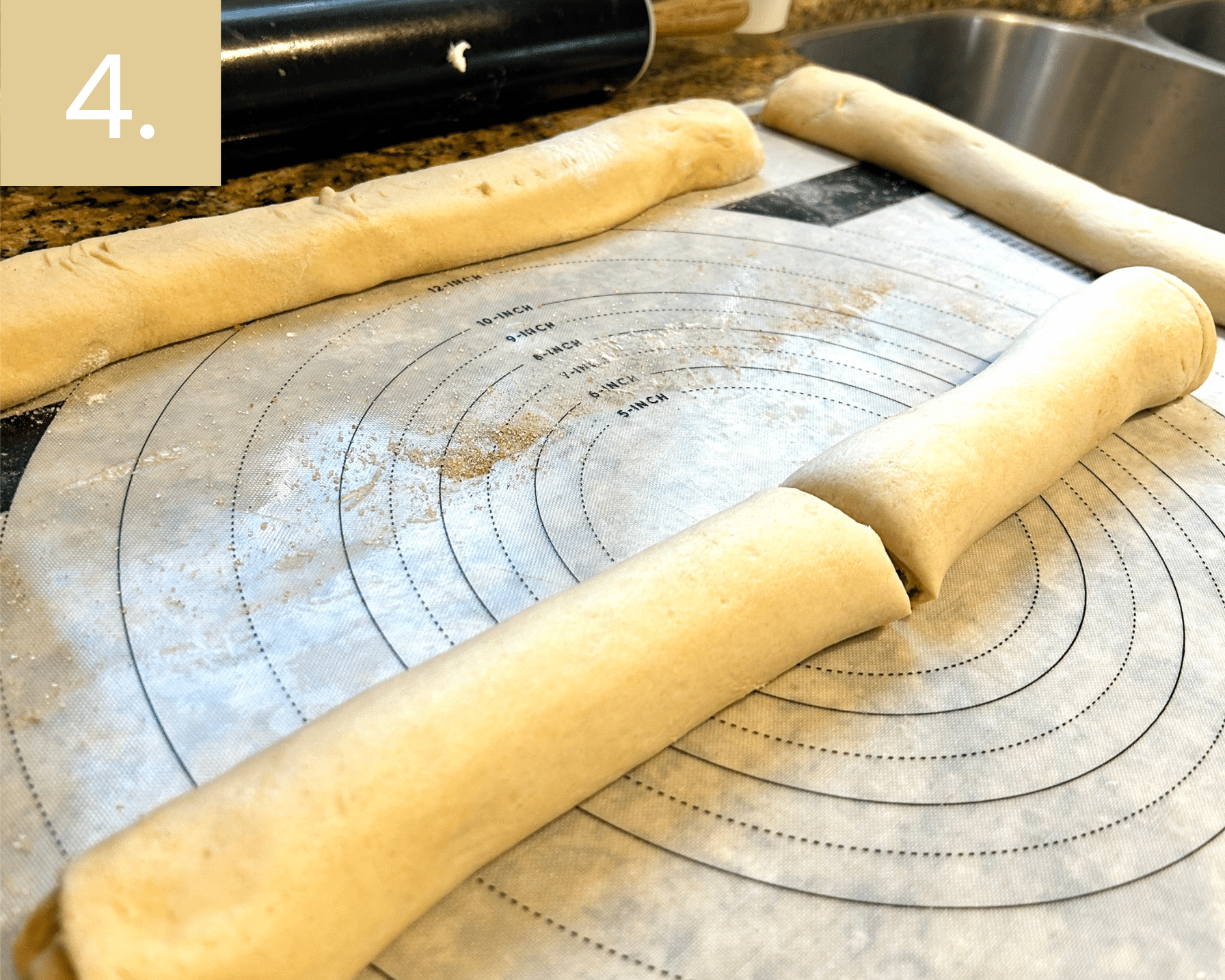 Rolling up dough tightly like cinnamon rolls and slicing in half to make cruffins.