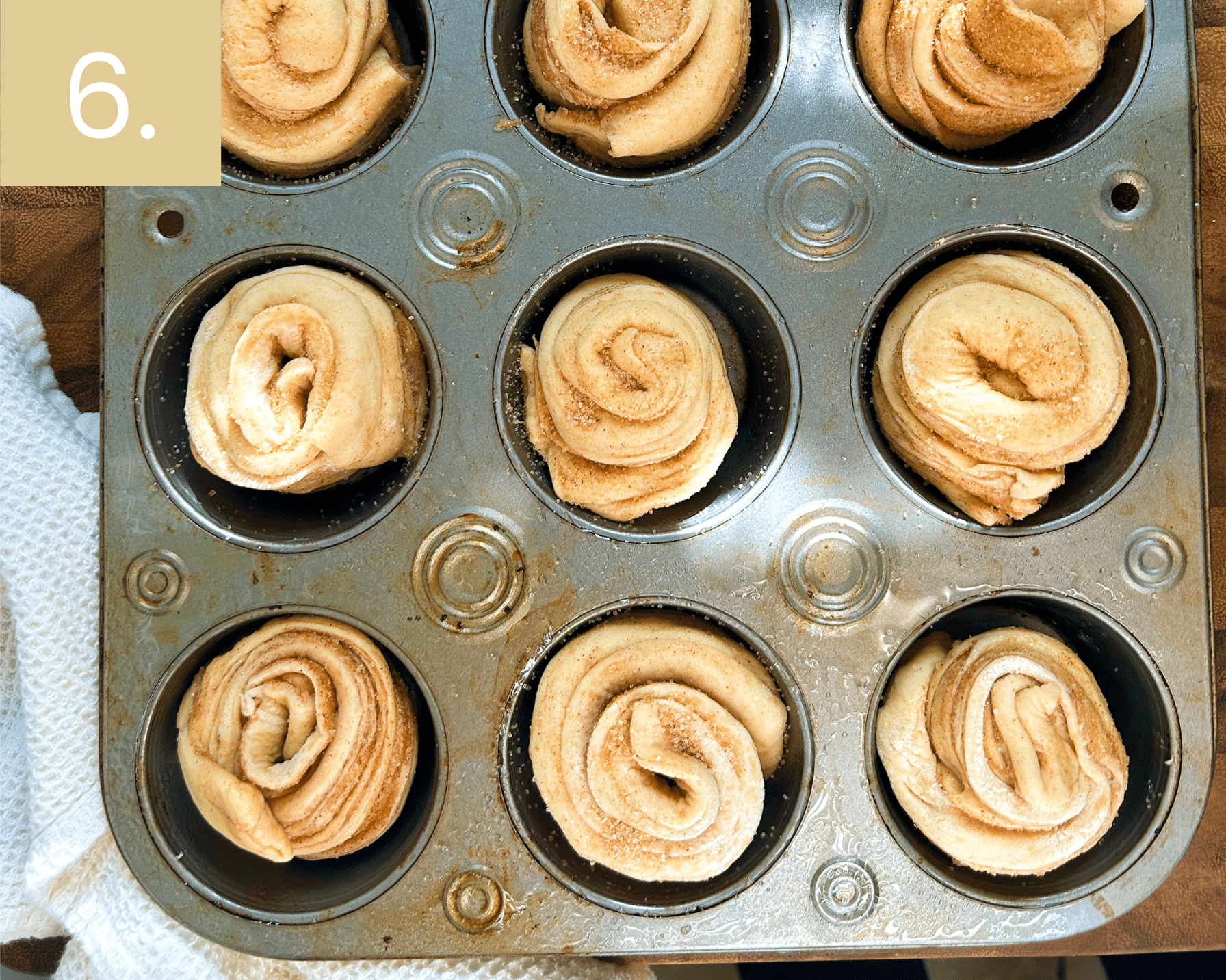 Wrapping cinnamon sugar dough strips into pinwheels and placing in muffin pan.