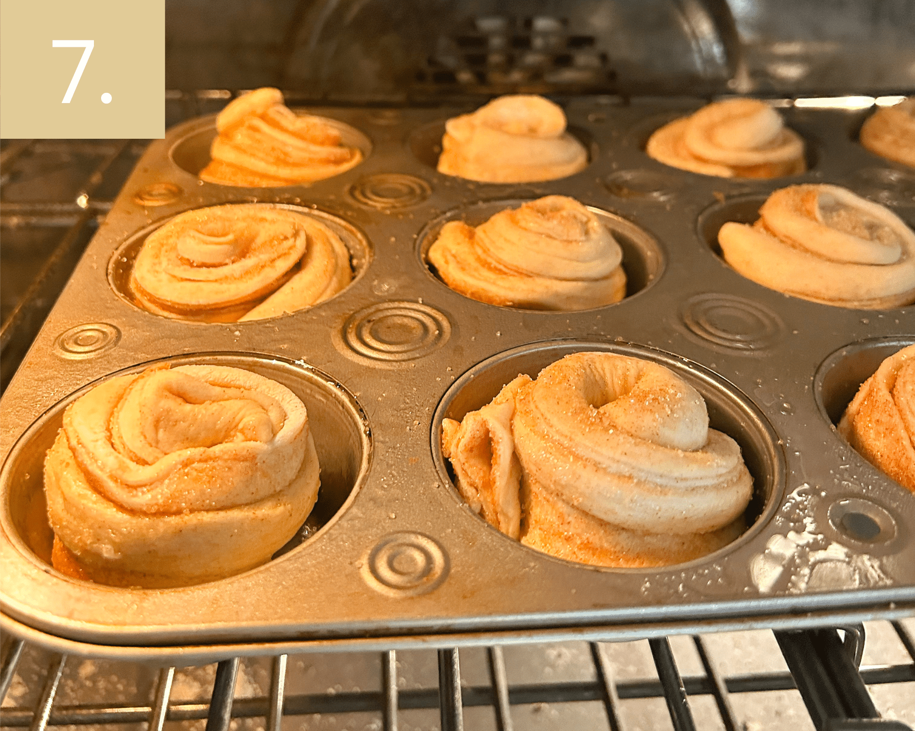 Baked cruffins puffed and golden brown fresh from the oven in muffin pan.