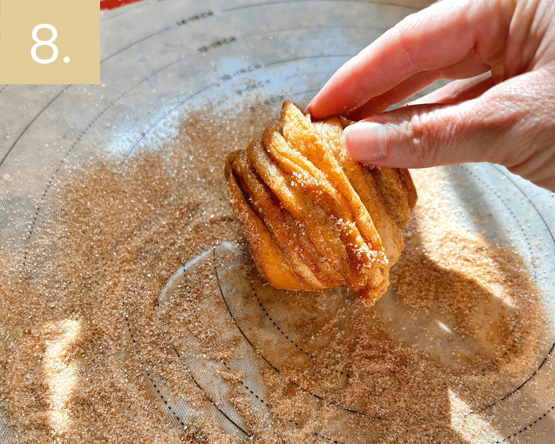 Rolling warm cruffins in extra cinnamon sugar for sweet churro-style finish.