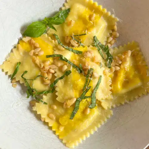 Trader Joe's Sweet Corn Ravioli cooked in Garlic Butter with fresh basil and pine nuts on top.