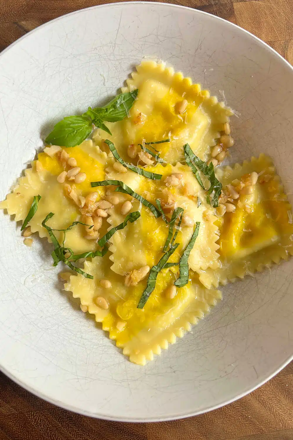 Trader Joe's Sweet Corn Ravioli cooked in Garlic Butter with fresh basil and pine nuts on top.