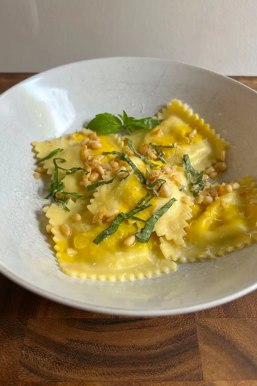 Trader Joe's Sweet Corn Ravioli cooked in Garlic Butter with fresh basil and pine nuts on top.