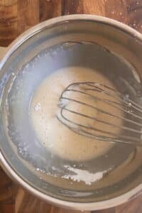 Whisking the vanilla glaze together.
