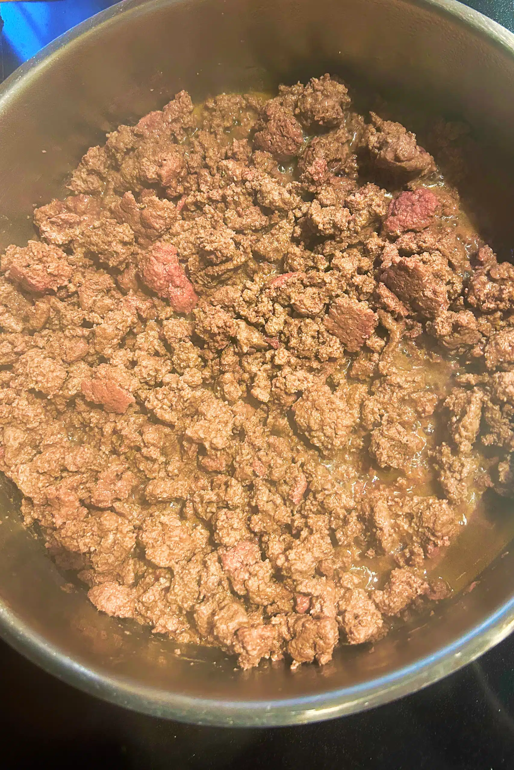 Browned ground beef in a pan.